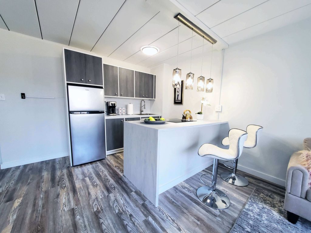 Shorewood Apartments, Cleveland, OH: renovated kitchen with stainless steel refrigerator, island and pendant lights